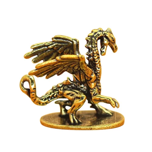 Figurine de dragon volant en métal posée sur un socle rond