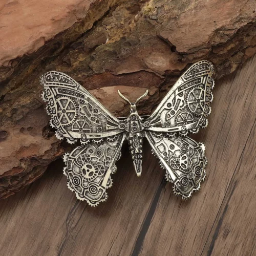 Pince à cheveux papillon bronze aux ailes sculptées de roues à rayons et de bielles